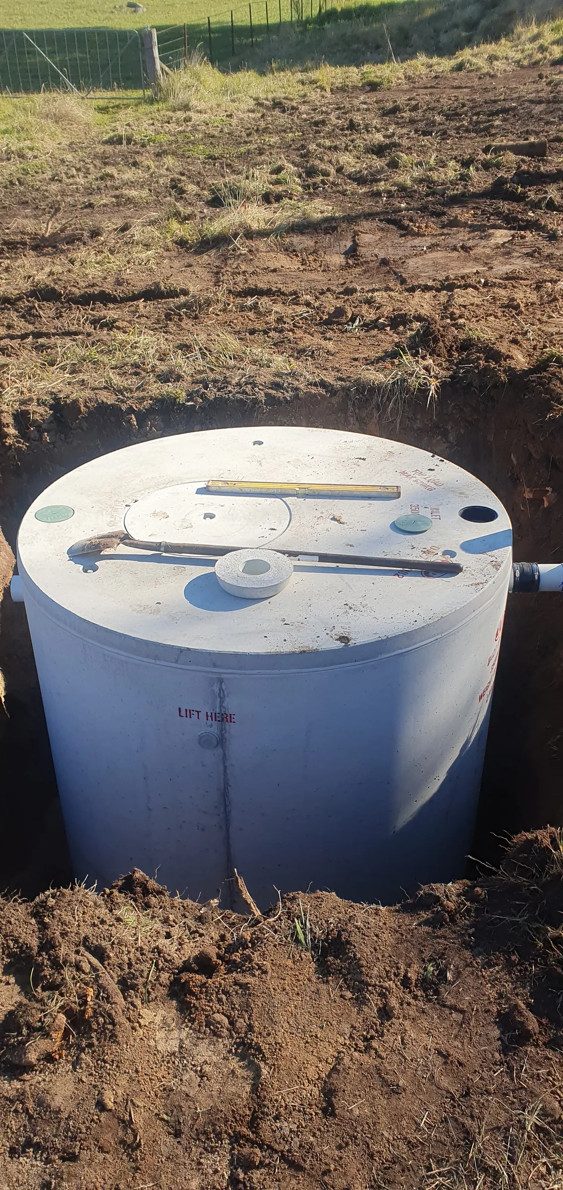 A new septic tank being lowered into an excavated pit on a Mid North Coast property